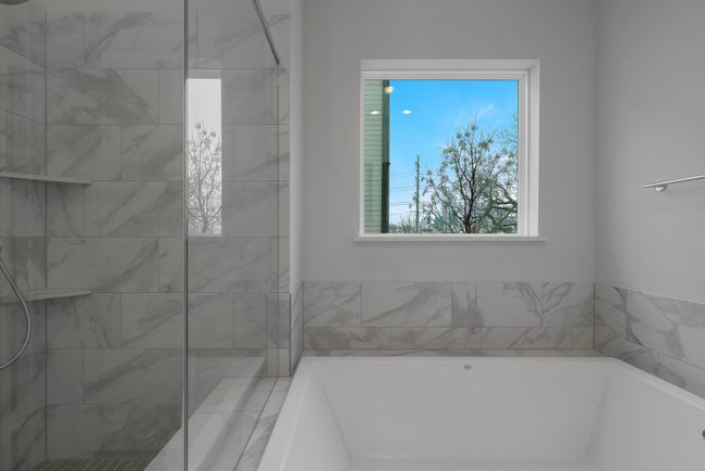 Bathroom with a tile shower and a garden tub | Image 25
