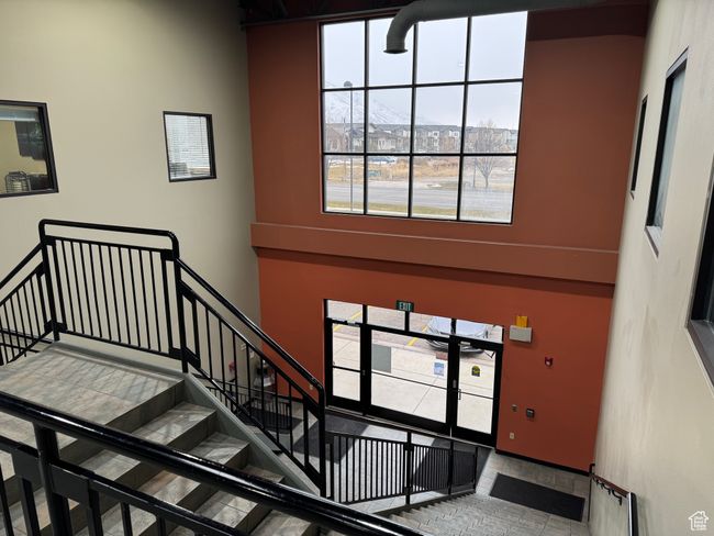 Staircase with a high ceiling and a wealth of natural light | Image 7