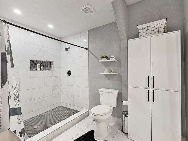 Bathroom with toilet, a shower stall, and recessed lighting | Image 14