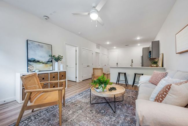 Living area featuring light wood finished floors, ceiling fan, baseboards, and recessed lighting | Image 18