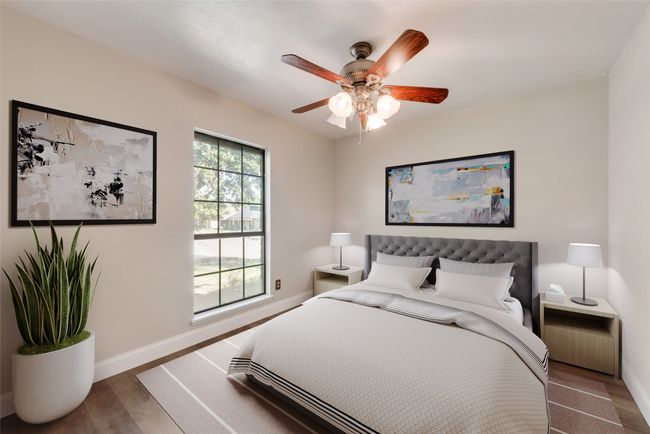 Bedroom with wood finished floors and a ceiling fan | Image 8
