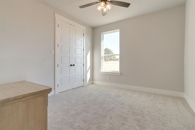 Empty room featuring ceiling fan, light colored carpet, and a wealth of natural light | Image 25