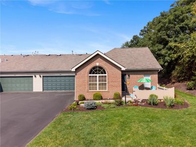 Brick patio home with appealing natural surroundings and nicely sized patio for relaxing or dining outdoors. | Image 2