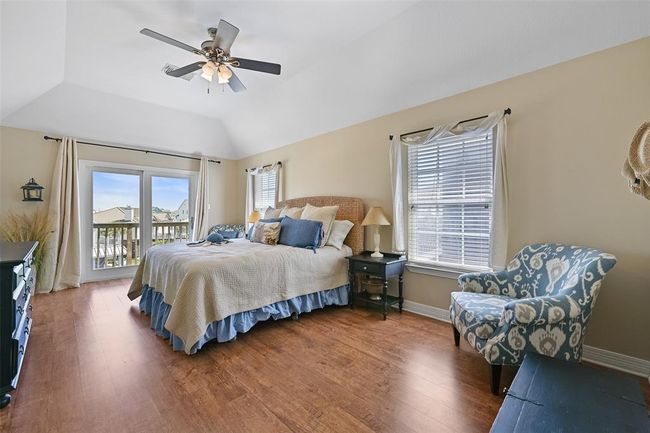Luxurious primary suite with canal views and a cozy sitting area. | Image 19