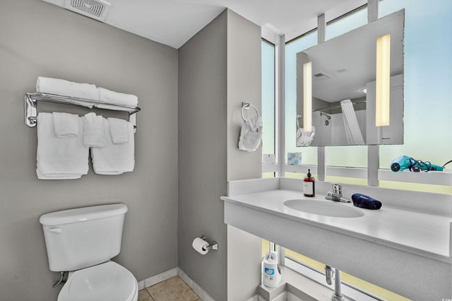 Full bath with visible vents, baseboards, toilet, vanity, and tile patterned floors | Image 26