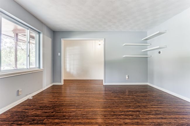 Empty room featuring wood finished floors and baseboards | Image 8