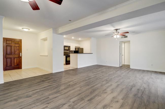 A nice foyer with art niche and you own laundry room. Wood floors in the foyer, living room, dining room | Image 7