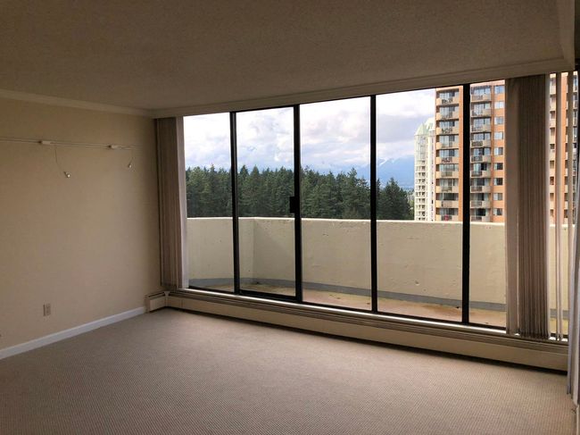 Unfurnished room with a baseboard heating unit, crown molding, carpet, and baseboards | Image 11