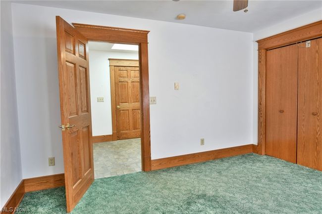 Unfurnished bedroom featuring a closet, carpet flooring, and ceiling fan | Image 22