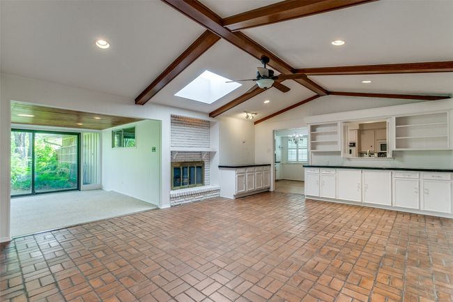 Fireplace and Built-ins Opens to Sunroom | Image 6