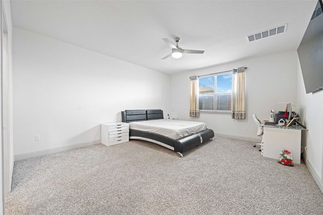 Carpeted bedroom featuring visible vents, baseboards, and ceiling fan | Image 20