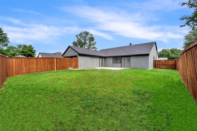 Rear view of property with a patio area and roof with shingles | Image 28
