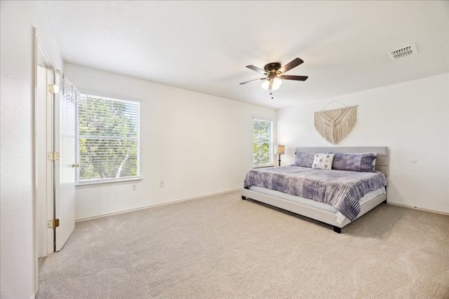 Carpeted bedroom featuring ceiling fan | Image 5