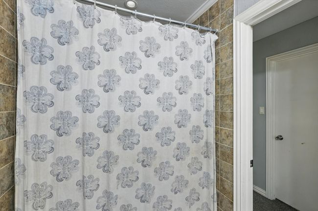 Full bathroom featuring curtained shower and baseboards | Image 21