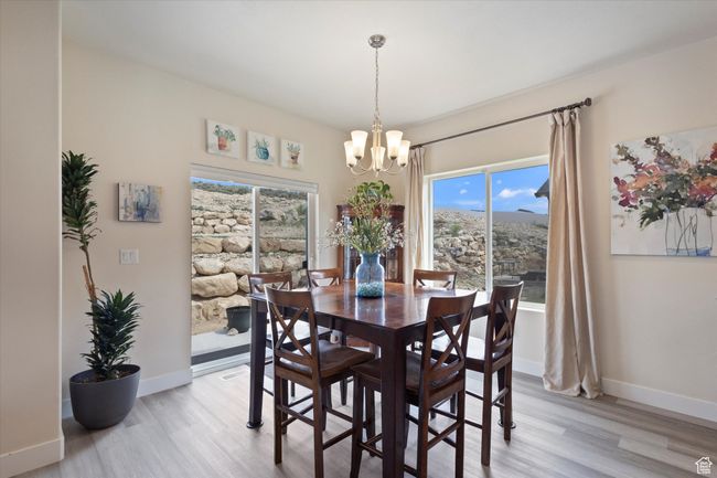 Dining room featuring a chandelier, light wood-type flooring, and healthy amount of natural light | Image 10