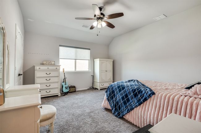 Bedroom with carpet, vaulted ceiling, and a ceiling fan | Image 18