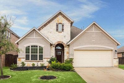 Stunning stone and stucco home in the beautiful master planned community of Cane Island. Located in the heart of old Katy is this 1 1/2 story home with five bedrooms. Home comes with a Generac generator. | Image 1