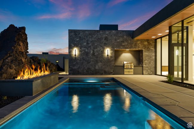 View of pool with a pool with connected hot tub, exterior kitchen, and a patio | Image 15