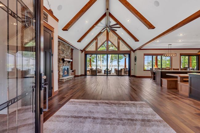 Step into the great room where expansive floor-to-ceiling windows Offer grand views of the lake. | Image 28