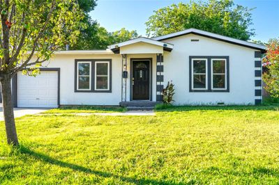 Single story home with a garage and a front yard | Image 1