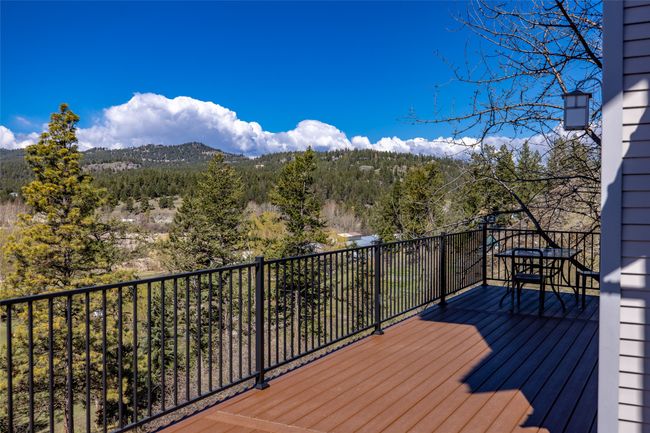 Wooden terrace with a view of trees | Image 85