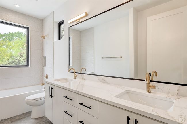 Full bath featuring double vanity, toilet, and shower / bath combination | Image 6