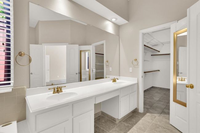 Bathroom with a spacious closet, a sink, and double vanity | Image 31