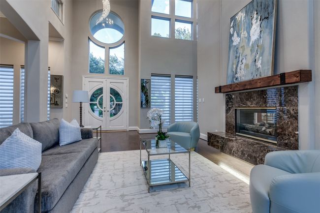 A view looking back to the front door, with the elegant front entry and spiraling crystal chandelier. Beautiful custom Hunter Douglas silhouette shades which raise and lower by an app on your phone. | Image 4