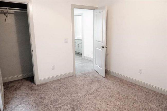 Unfurnished bedroom featuring carpet, baseboards, and a closet | Image 11