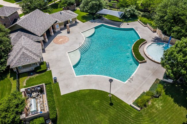Community pool with a patio area | Image 36