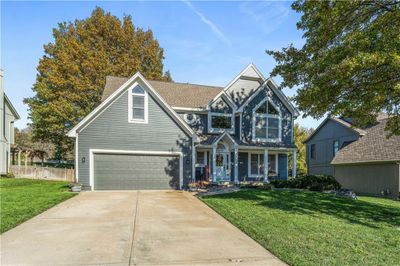 View of front of home with a garage and a front yard | Image 1