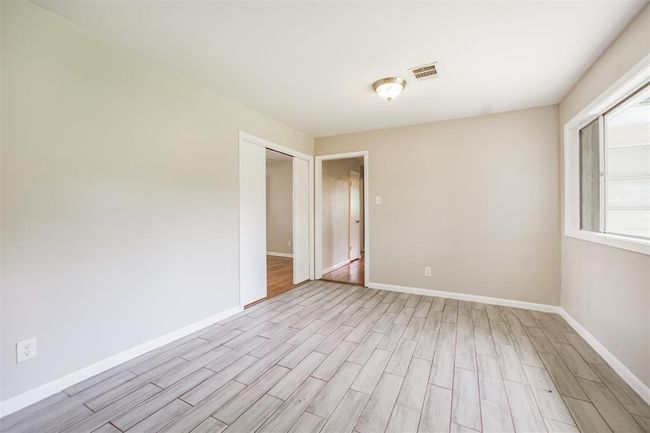 Dining room has wood look ceramic tile flooring | Image 13