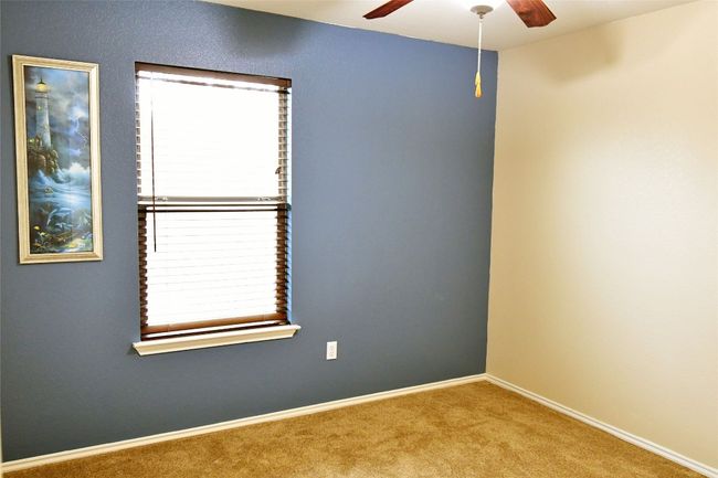 Carpeted spare room featuring ceiling fan and baseboards | Image 21