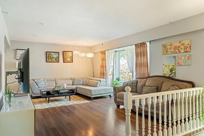 Living room featuring a textured ceiling and dark wood-style floors | Image 7