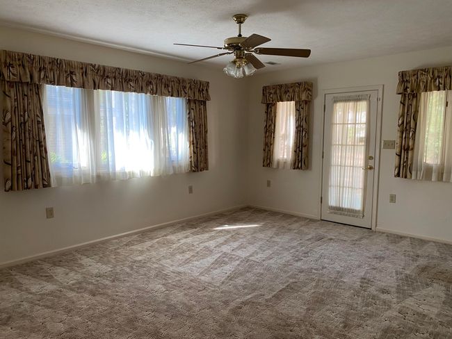 Den has door to patio | Image 24