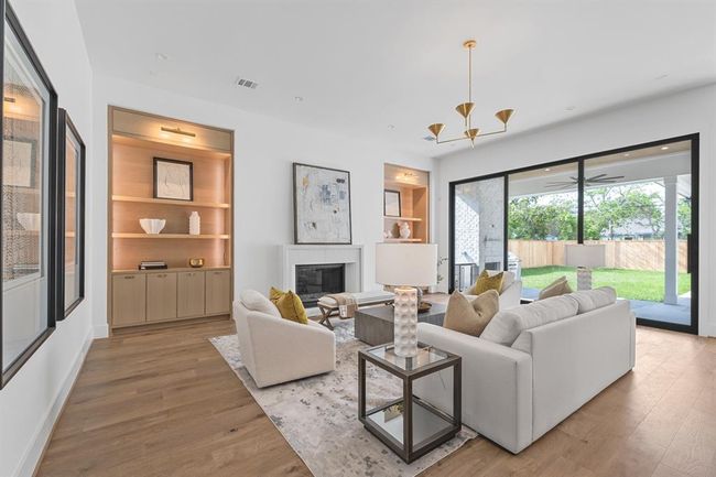 A wide expanse of white oak flooring fills the frame, showcasing its natural grain and light tones. The flooring stretches into a large, open living space, suggesting a modern and airy interior design | Image 23