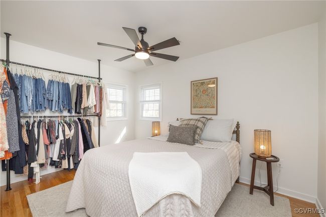 Bedroom with baseboards, a closet, ceiling fan, and wood finished floors | Image 23