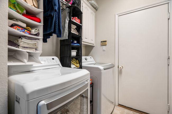 Laundry area featuring cabinet space and independent washer and dryer | Image 28