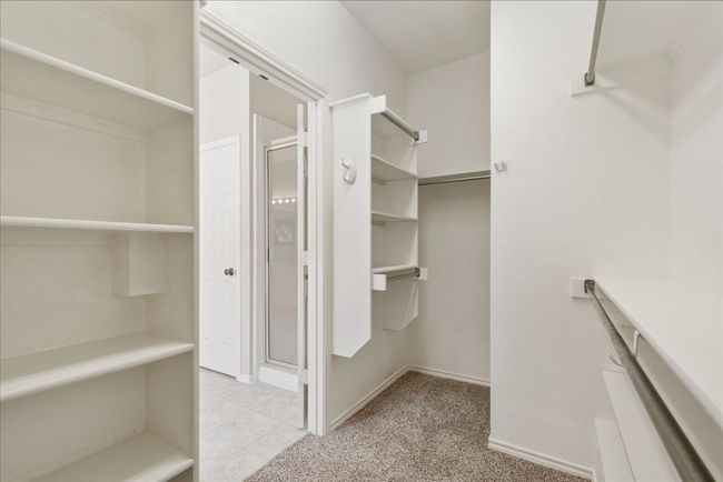 Spacious walk in closet with lots of shelving | Image 14