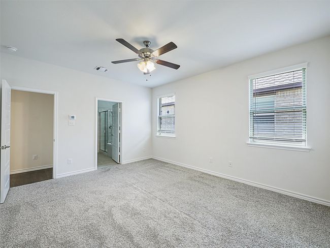 Unfurnished bedroom with carpet floors, ensuite bath, and a ceiling fan | Image 13