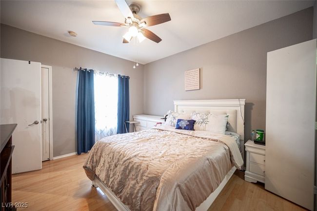 Bedroom with light wood-style flooring and ceiling fan | Image 20