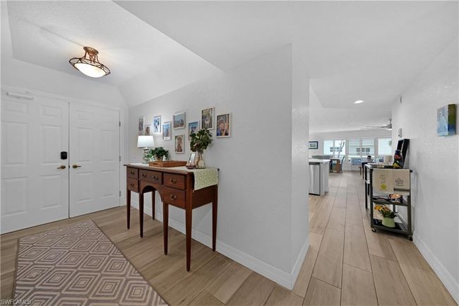 Foyer with light hardwood / wood-style floors, ceiling fan, and lofted ceiling | Image 6