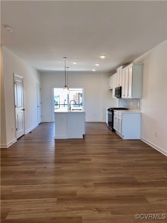 Kitchen with stainless steel microwave, baseboards, gas stove, and recessed lighting | Image 11