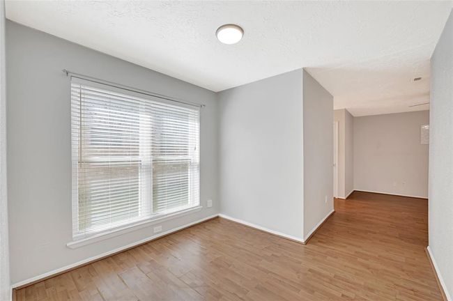 Cozy sitting area leading into the primary bedroom, perfect for relaxation or reading. | Image 17