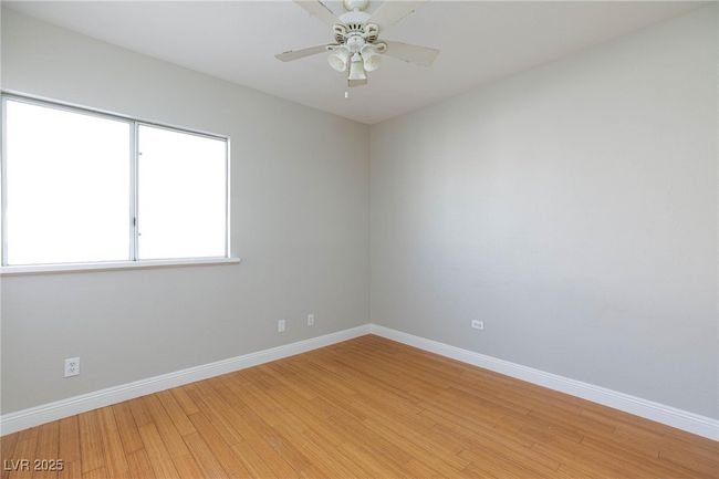Unfurnished room with baseboards, light wood-type flooring, and ceiling fan | Image 33