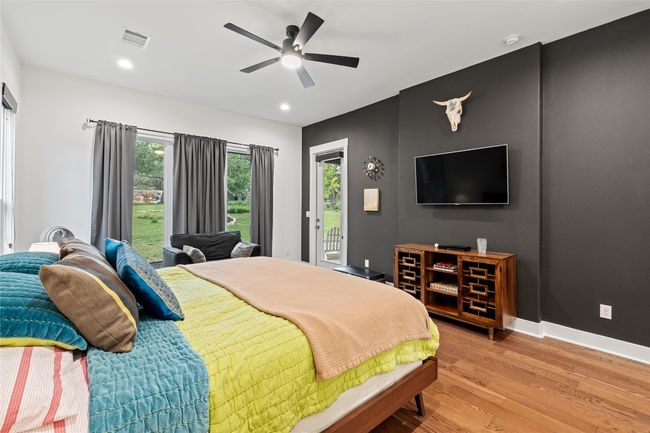 Bedroom with access to exterior, light wood finished floors, baseboards, ceiling fan, and recessed lighting | Image 15