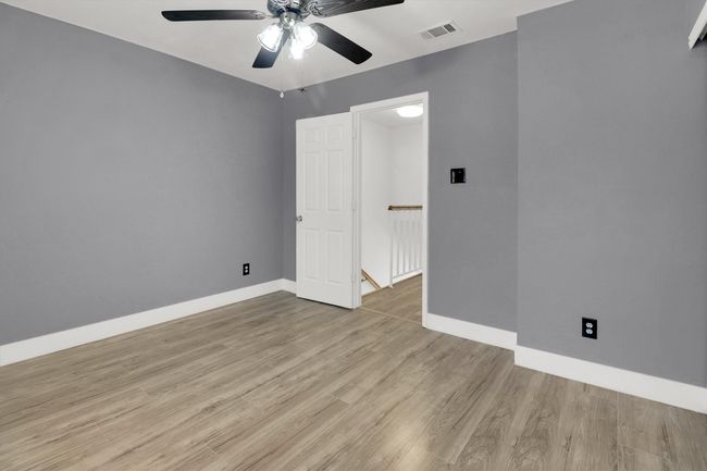 Unfurnished bedroom featuring light wood-type flooring and a ceiling fan | Image 16