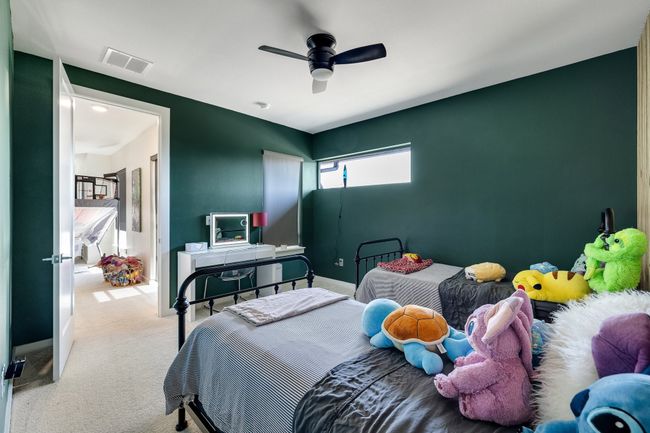 Bedroom featuring carpet flooring and ceiling fan | Image 32