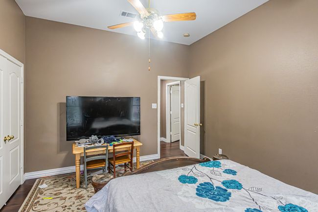 Bedroom featuring dark wood-style floors and ceiling fan | Image 28