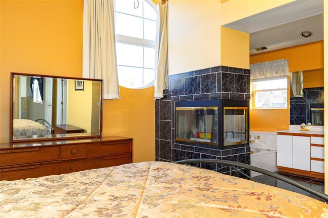 Primary Bedroom with a double sided fireplace | Image 25